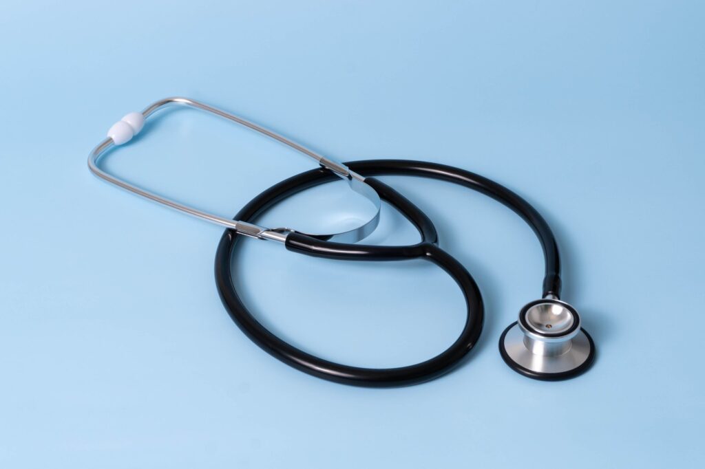 Trusted Pet Professionals & Specialist Vets | SDA Network 9 Close-up of a classic stethoscope on a blue background, symbolizing healthcare and medical profession.